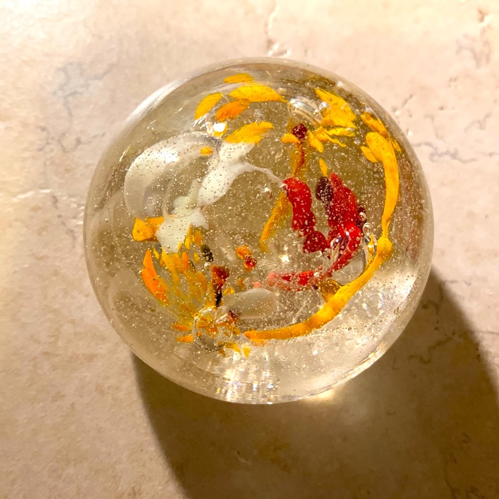 Small heavy glass art with organge, red and white bursts